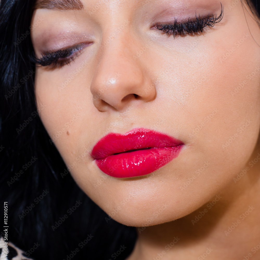 Obraz premium closeup portrait of beautiful sexy young lady with red lipstick relaxing eyes closed