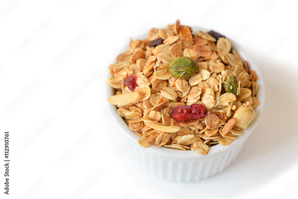 Homemade granola with honey, oatmeal, nuts raisin and cranberry on white background
Homemade granola with honey, oatmeal, nuts raisin and cranberry on white background