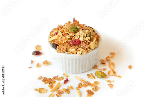 Homemade granola with honey, oatmeal, nuts raisin and cranberry on white background 