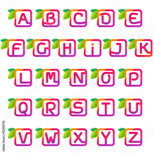 Alphabet square with juice and green leaves.