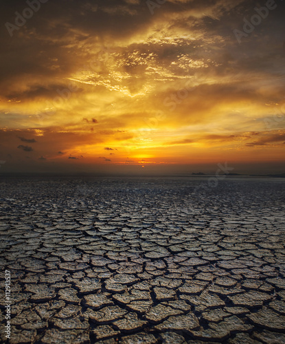 global warming. dramatic sky over cracked earth