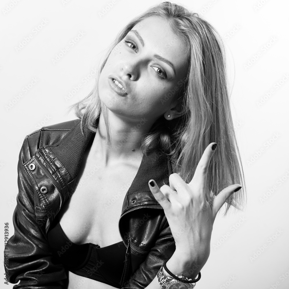 fashion rock star series: black and white portrait of sexy young blonde  lady in leather jacket posing over light copy space background Stock Photo  | Adobe Stock