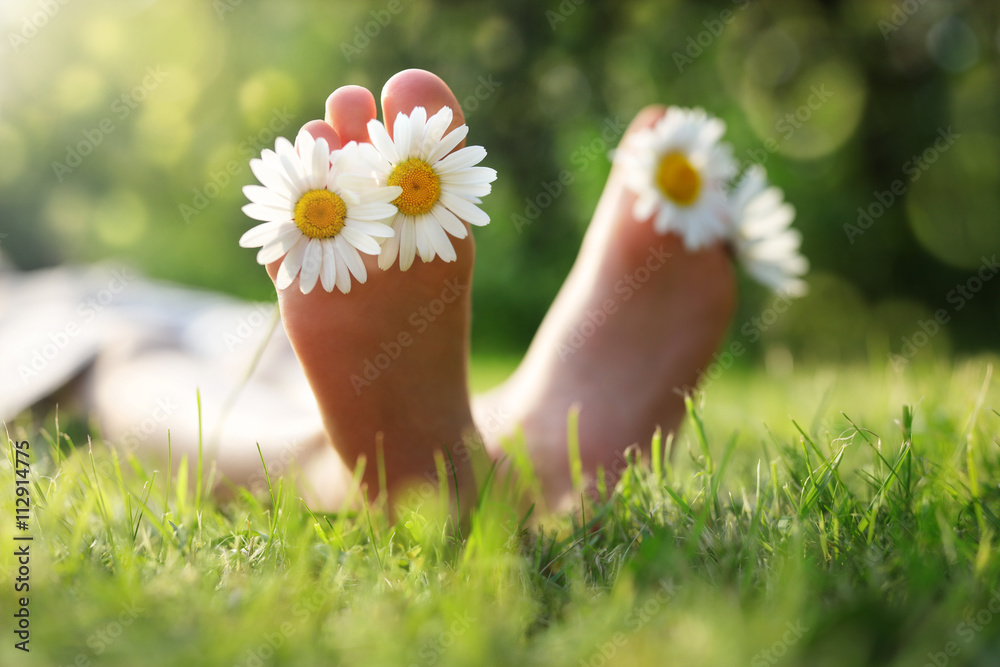 Child lying in meadow relaxing in summer sunshine Child lying in meadow relaxing in summer sunshine