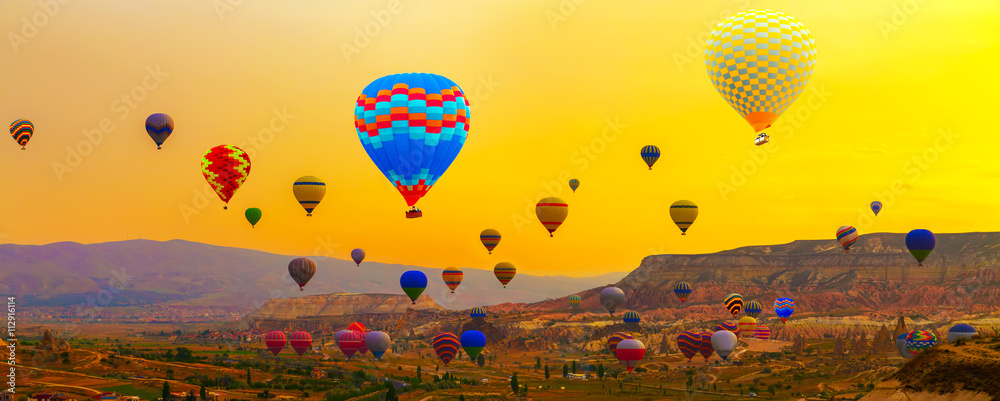 Fototapeta premium Colorful Hot Air Balloon In The Mountain sunrise