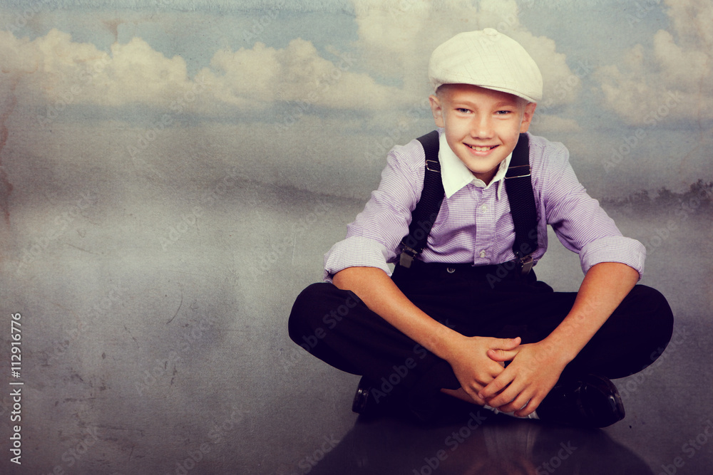 Old fashioned boy sitting. Photo in retro style. Old fashioned boy sitting. Photo in retro style.