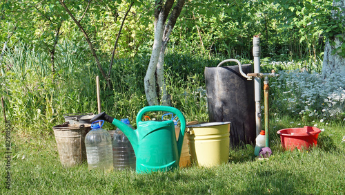  buckets and canisters with water in garden