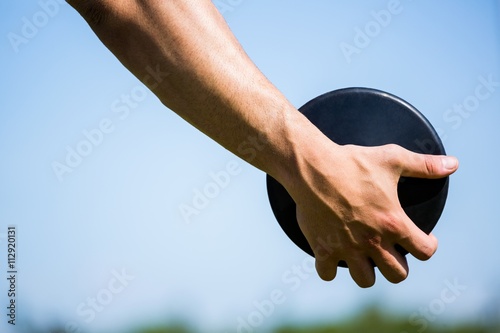 Photos Close-up of hand holding a discus