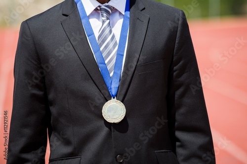 Businessman wearing gold medal