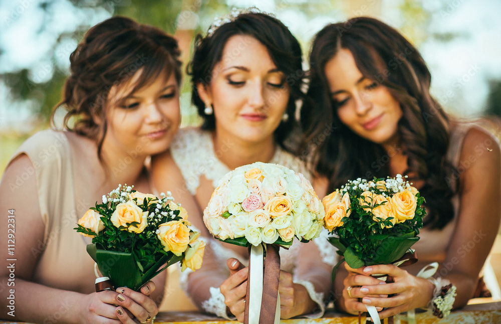 Bride with bridesmaids on the park on the wedding day Bride with bridesmaids on the park on the wedding day