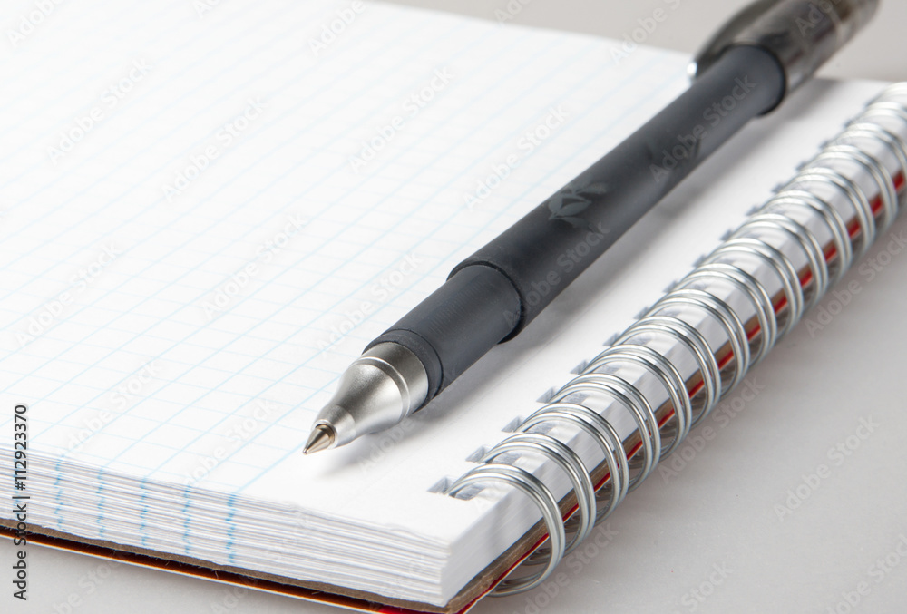 Blank sheet of notebook with metal spiral and pen Blank sheet of notebook with metal spiral and pen