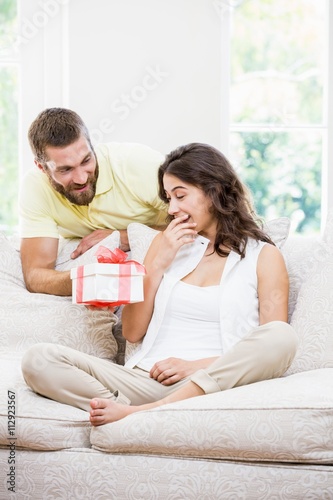 Man giving a surprise gift to her woman