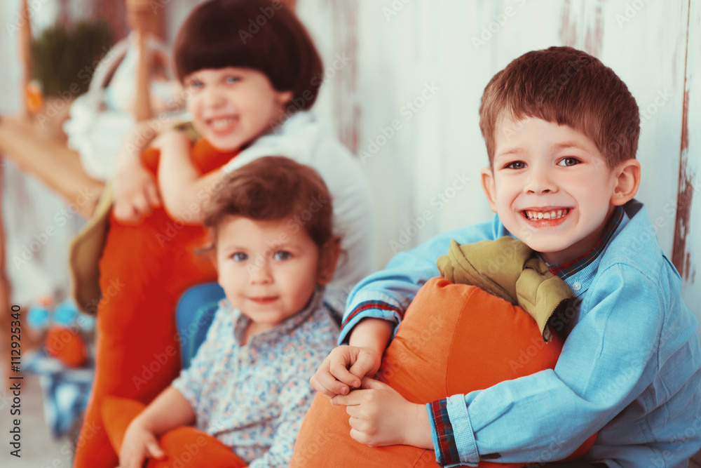 Three beautiful laughing little children in the spring Easter interior photo Studio Three beautiful laughing little children in the spring Easter interior photo Studio