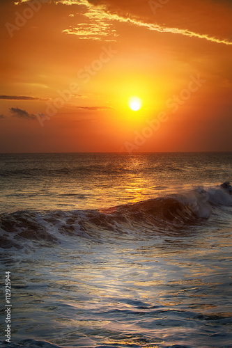 Sunrise in the sea with soft wave and cloudy