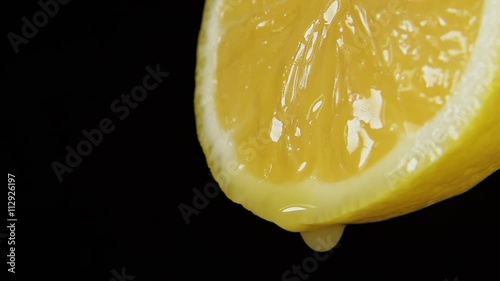 SLOW MOTION: A juice drops falls from a lemon