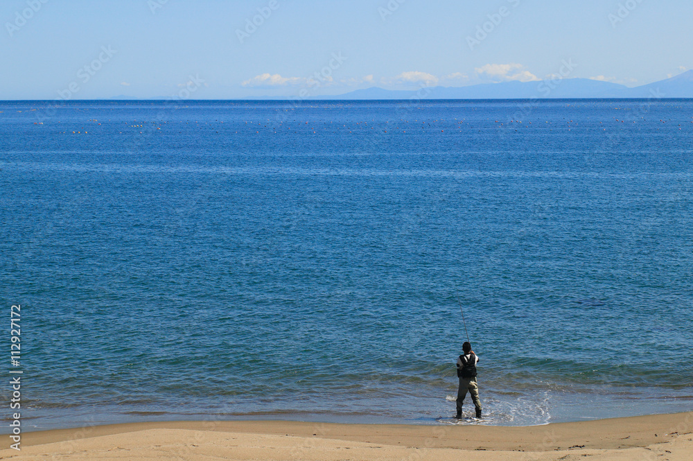 波打ち際の釣り人