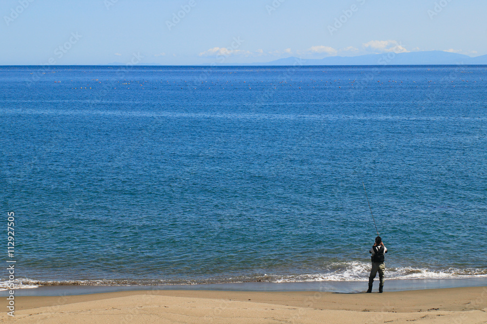 波打ち際の釣り人