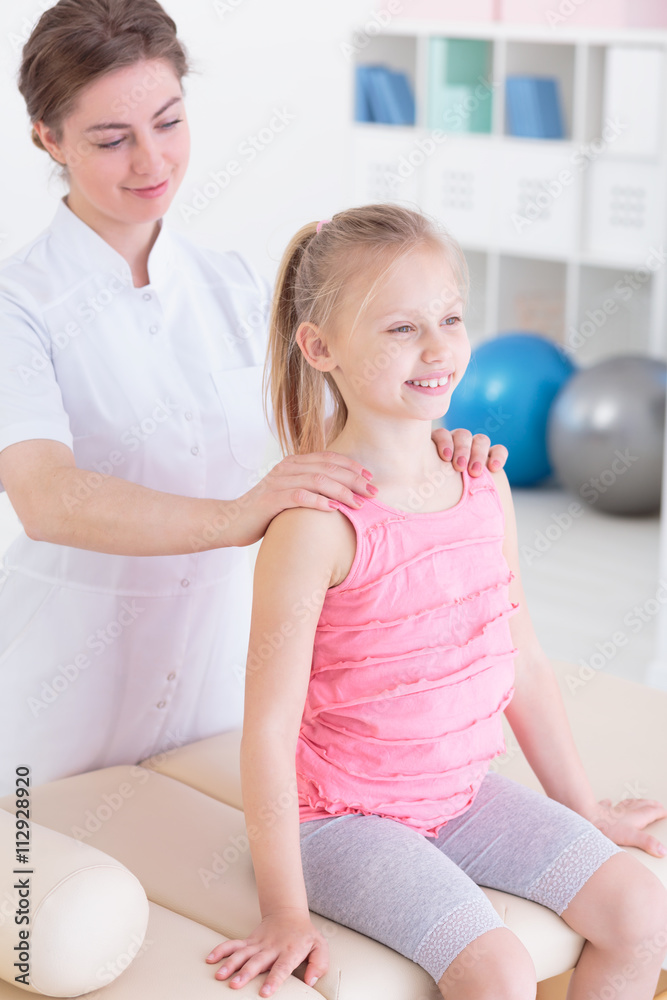 Fototapeta premium Examining her spine to adjust therapy plan