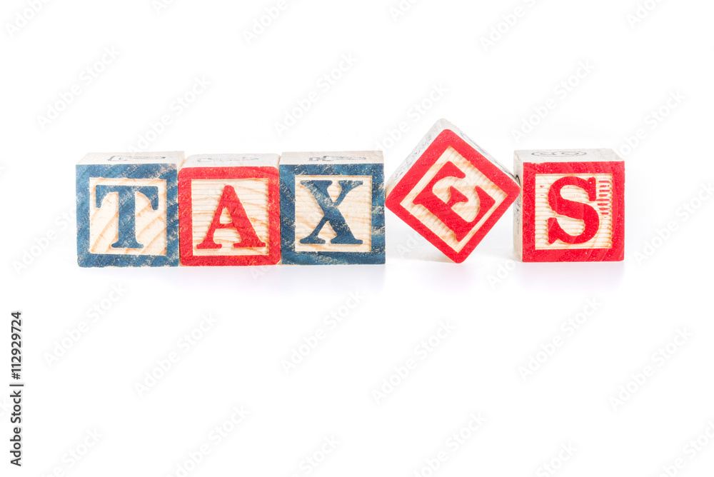photo of a alphabet blocks spelling TAXES isolate on white backg photo of a alphabet blocks spelling TAXES isolate on white backg