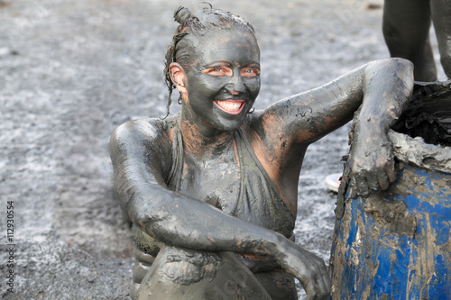 Portrait of woman covered in therapeutic mud, Dead Sea, Israel photo