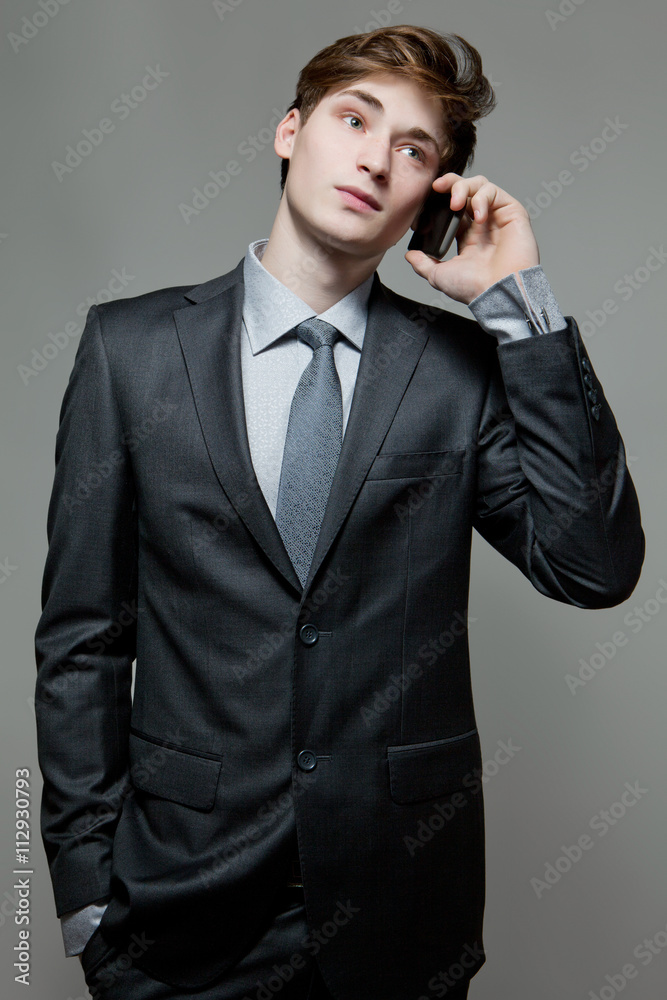 Fototapeta premium Young business man talking on cell phone