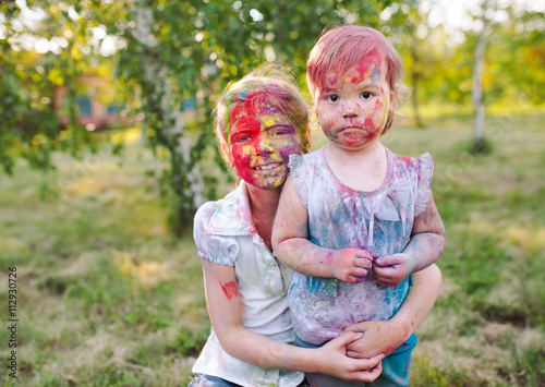 portrait of the sisters  painted in the colors of Holi.