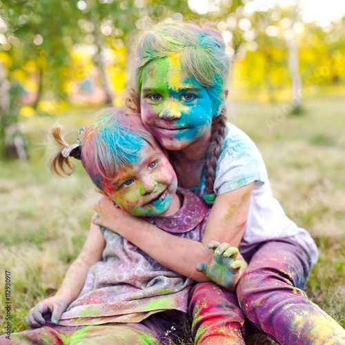 portrait of the sisters, painted in the colors of Holi.