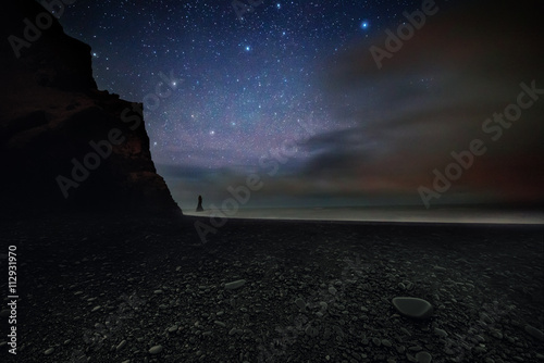 Scenic view of coastline against starry sky at night