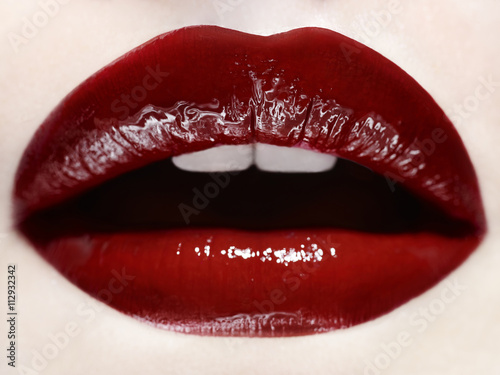 Close up of woman's mouth wearing red lipstick
