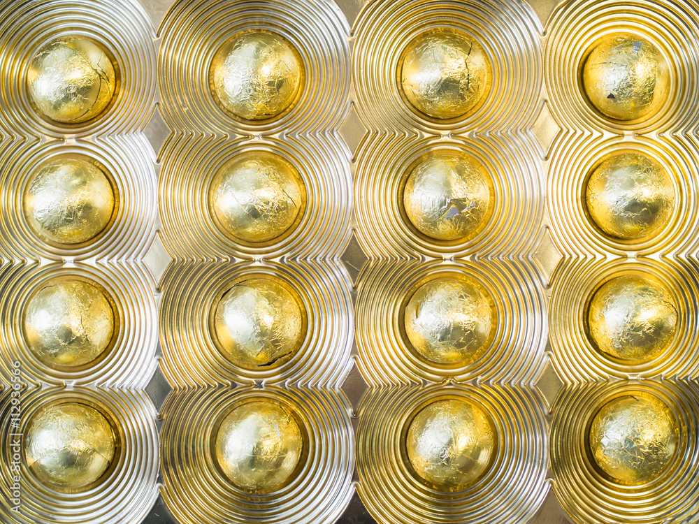 Chocolate ball dessert in gold metalic foil Chocolate ball dessert in gold metalic foil