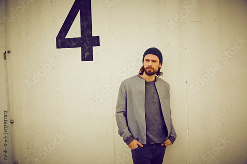 Cool mid adult man leaning against wall number four