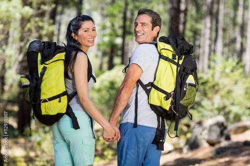 Couple from the back smiling and turning around the camera 