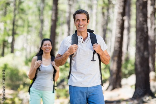 Couple smiling and hiking 