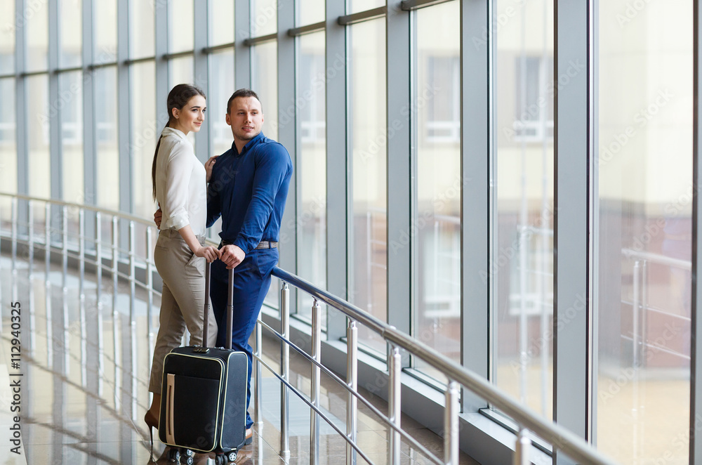 Couple in love on vacation. Couple standing in the airport. Couple in love on vacation. Couple standing in the airport.