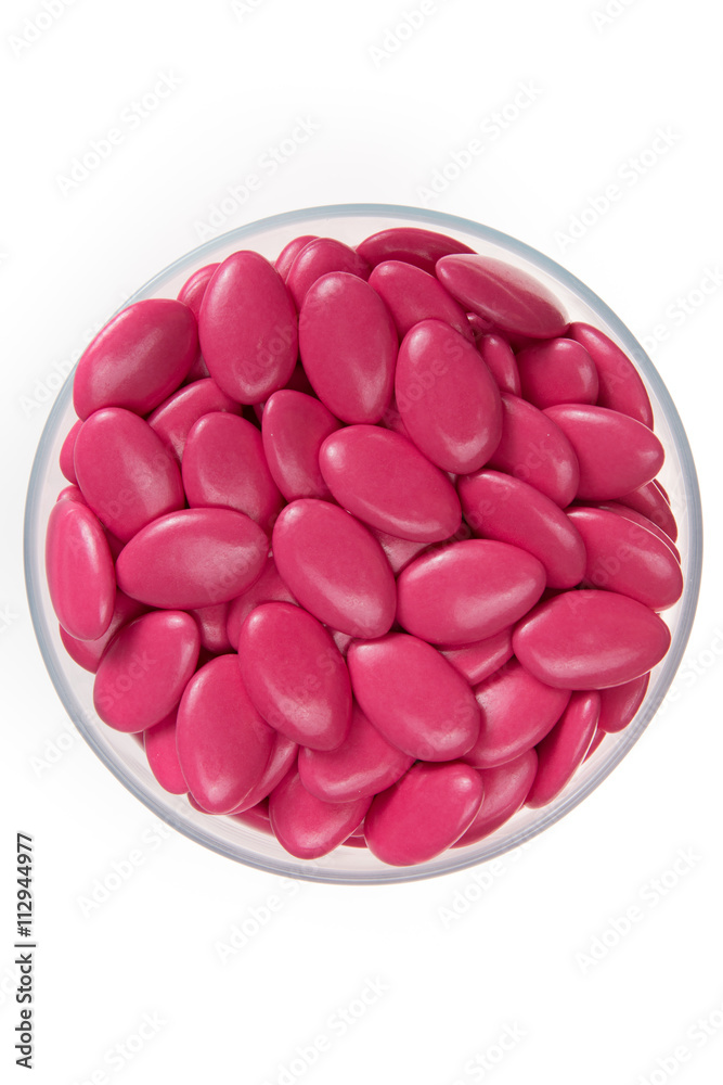 Pink sugar covered almonds surface top view heart symbol Pink sugar covered almonds surface top view heart symbol