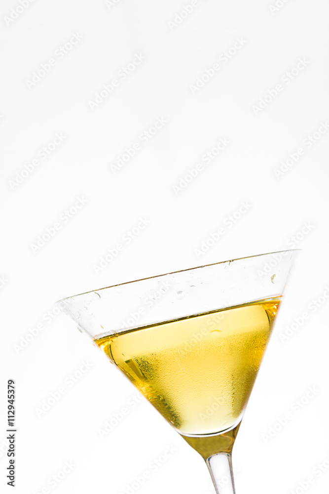 Yellow cocktail into a glass isolated on white background
Yellow cocktail into a glass isolated on white background