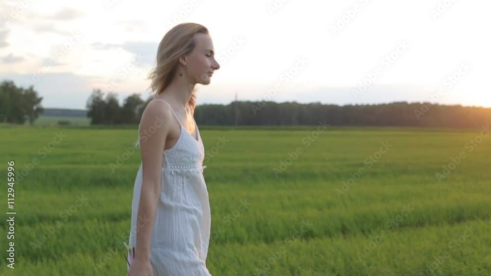 beautiful woman walking in the field with a bouquet of flowers beautiful woman walking in the field with a bouquet of flowers
