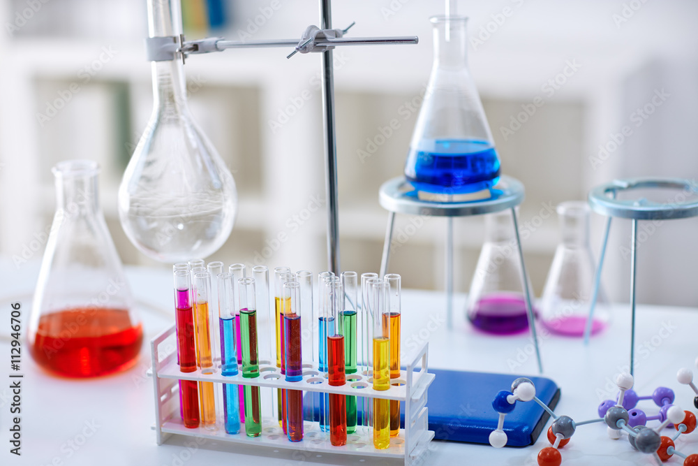 desk in chemistry lab with samples in test tubes.
