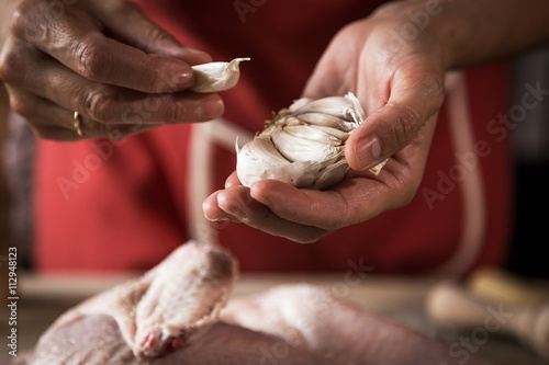 Unrecognizable woman cooking chicken