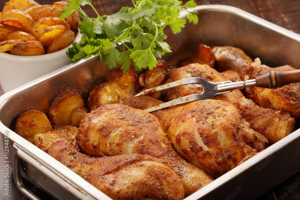 Roasted chicken legs with potato chips and vegetables Roasted chicken legs with potato chips and vegetables