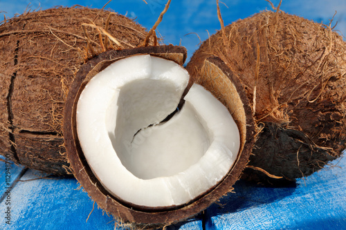 Cloven coconut on a blue wooden background