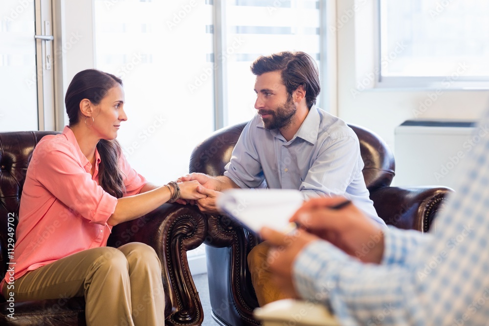 Psychologist helping a couple with relationship difficulties Psychologist helping a couple with relationship difficulties