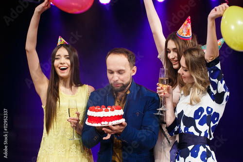 Happy birthday! Group of smiling friends gathered together with