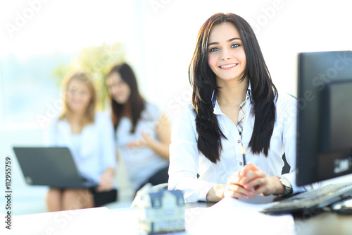 A real estate agent with a model home in the workplace