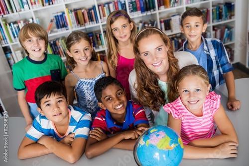 teacher and pupils posing with globe