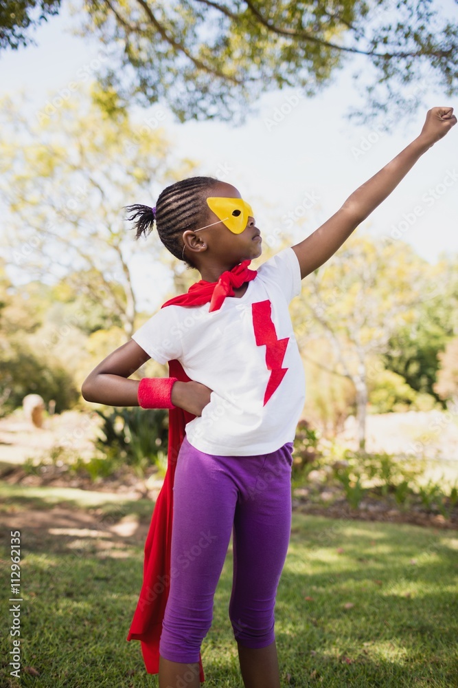 A little girl pretending to fly with superhero costume A little girl pretending to fly with superhero costume