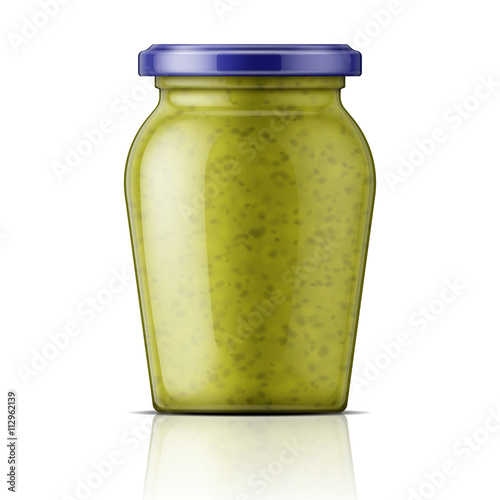 Glass jar with pesto sauce.