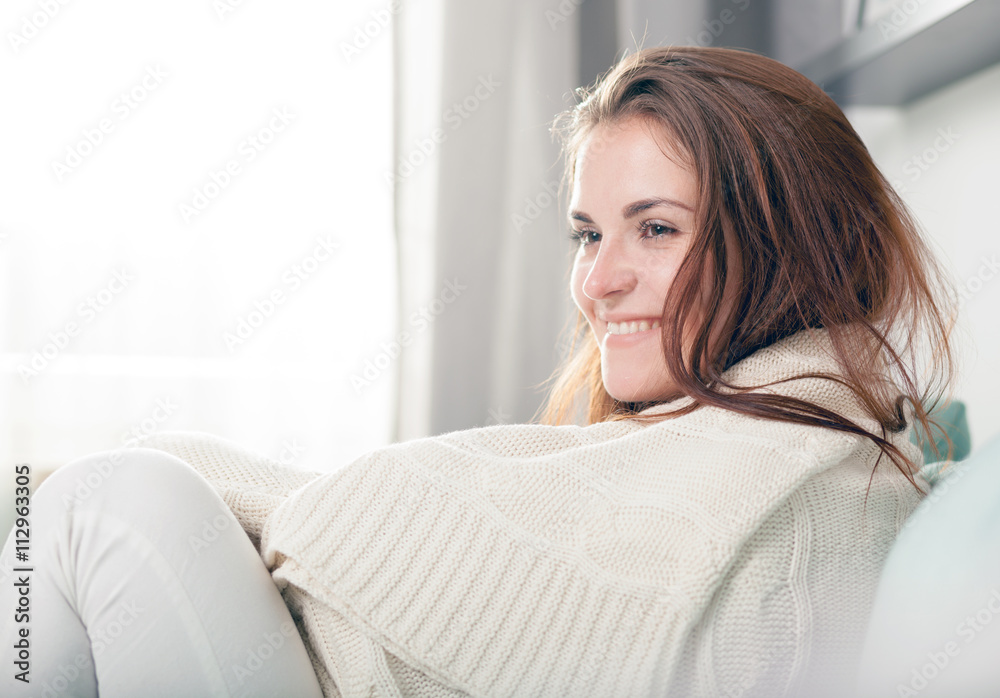 Happy young woman lying on couch and relaxing at home. Casual style indoor shoot Happy young woman lying on couch and relaxing at home. Casual style indoor shoot