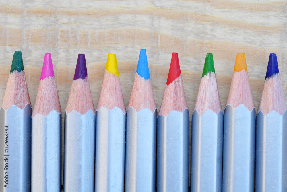 Close up Stack Colour Pencils on Wooden Background Close up Stack Colour Pencils on Wooden Background