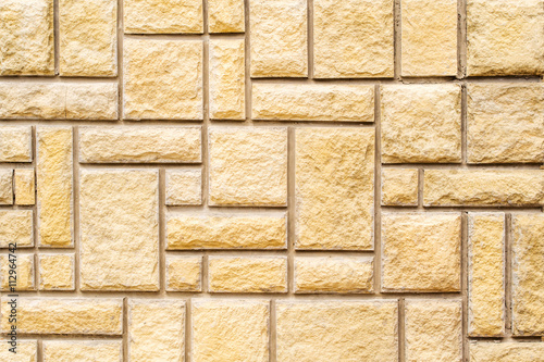 brown stone wall with grey concrete lines