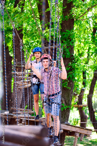 adventure climbing high wire park - people on course in mountain